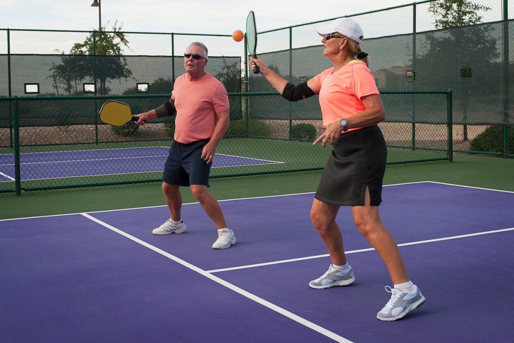 couple playing with racquets hobbies for seniors