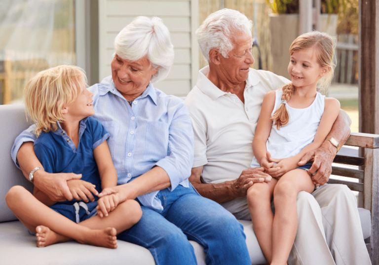 Outdoor park bench, family laughter, wide group shot, sunny afternoon light, editorial travel photo, grandparents with grandkids.