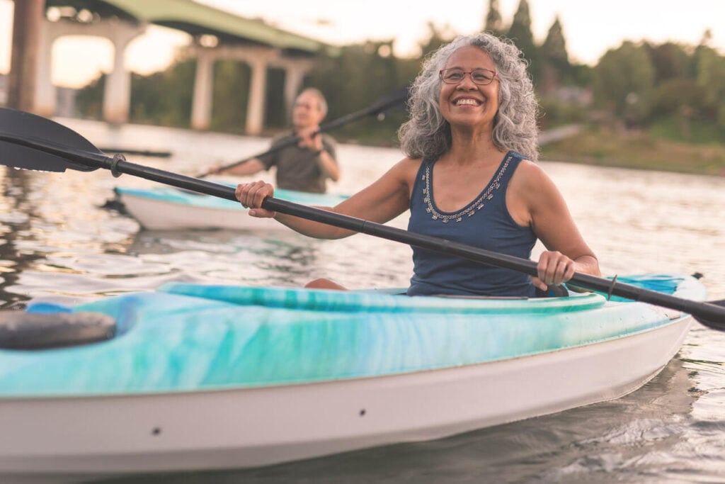 happy senior woman enjoying water activities life after retirement