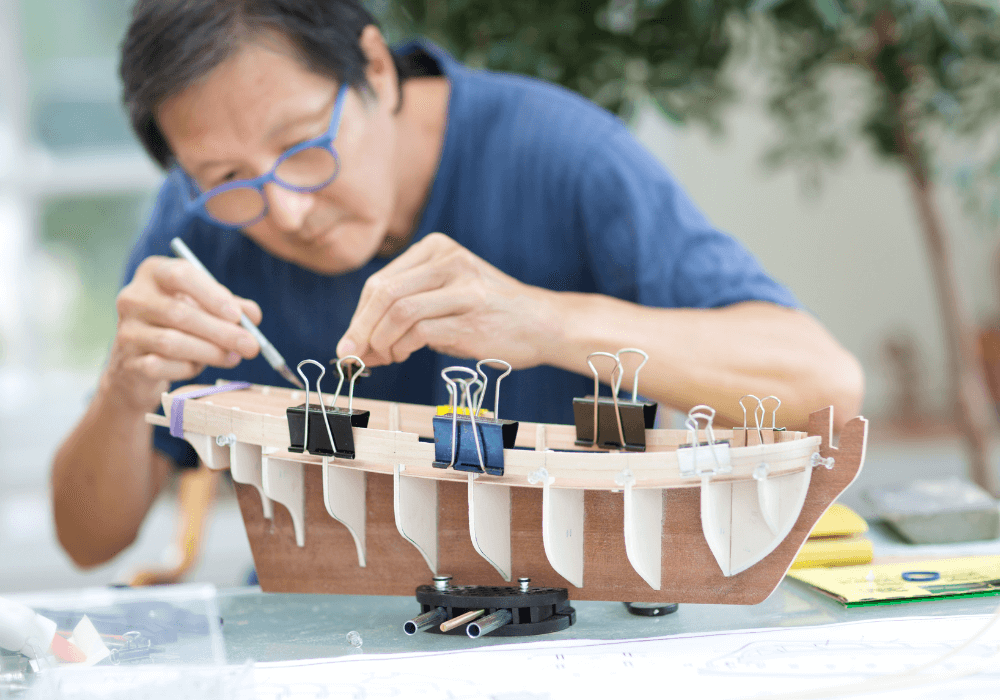 senior man doing arts and crafts after retirement retirement bucket list ideas