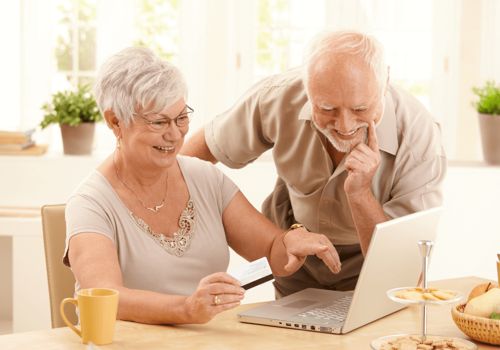 senior couple watching something on the laptop trivia for seniors
