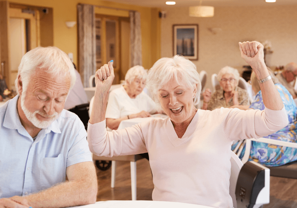 senior couple in a group setting being happy trivia for seniors