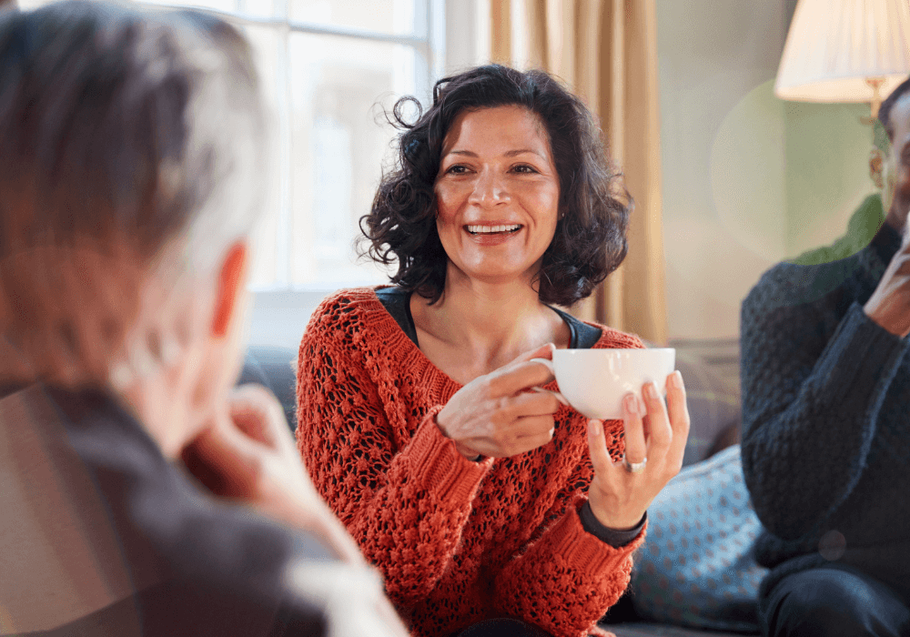 woman holding a cup smiling how to reinvent yourself at 50