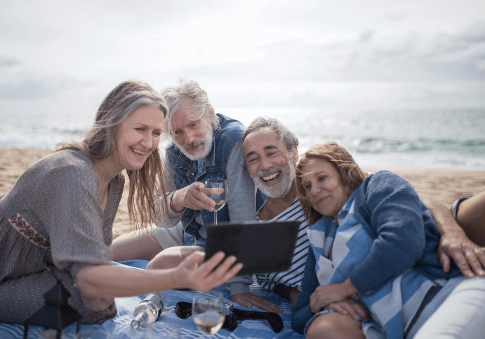 group of senior friends drinking at the beach how to reinvent yourself at 50