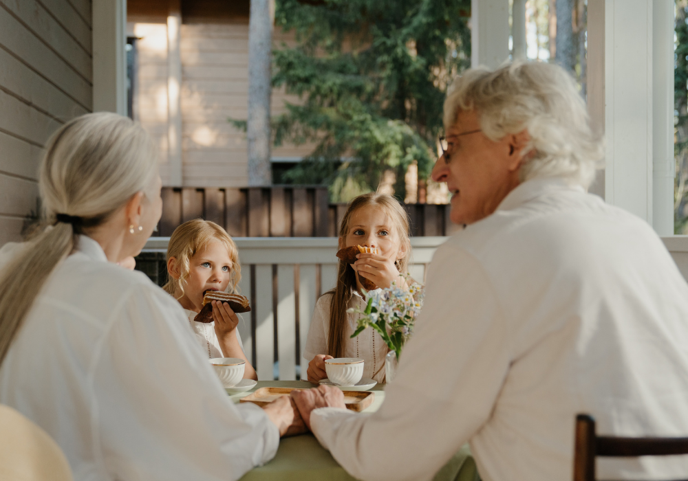 children eating looking at their grandma