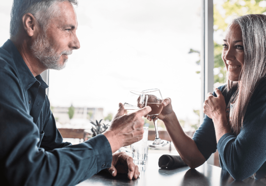 couple drinking wine at dinner Dating Profile Examples for Women Over 50