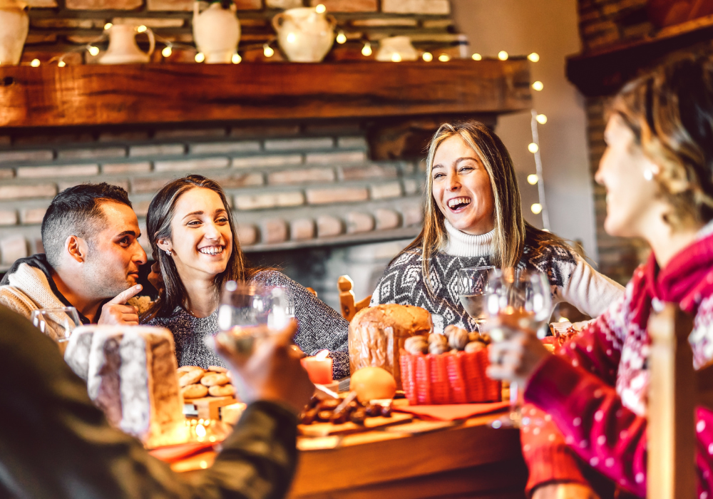 Festive dining room, holiday table centerpiece, four people gathered, evening warm lighting, editorial travel photo, with people.