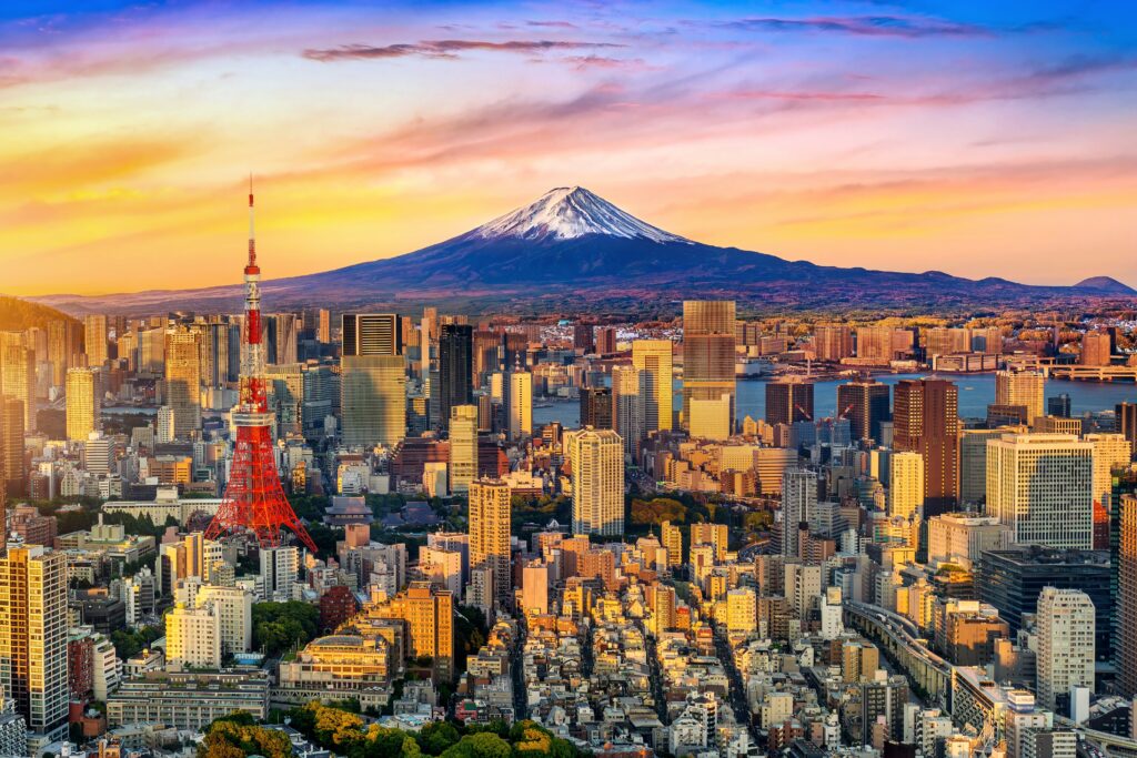 Tokyo, Tokyo Tower foreground, Mount Fuji background, vibrant sunset light, editorial travel photo, no people.